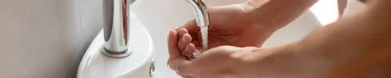 Washing hands at basin